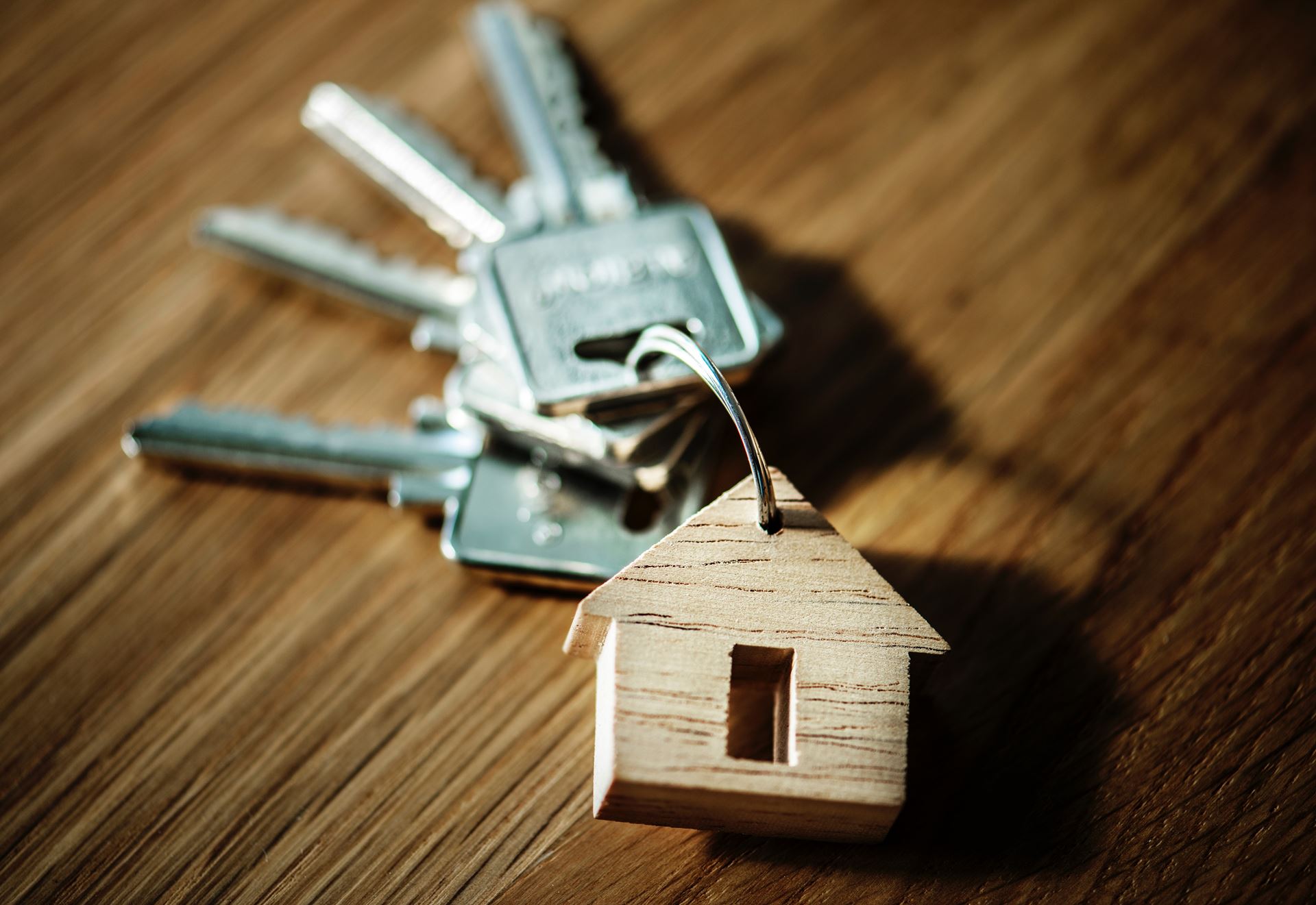 a set of keys on a wooden table